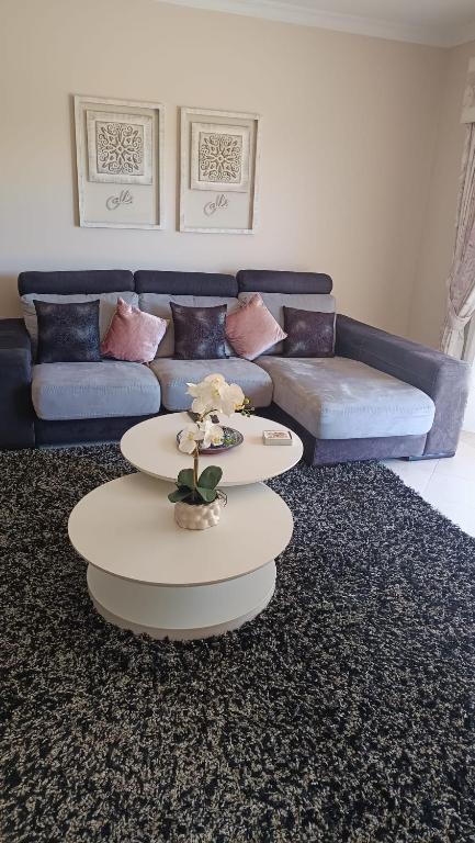 a living room with two tables and a couch at Sol Apartments in Vilamoura