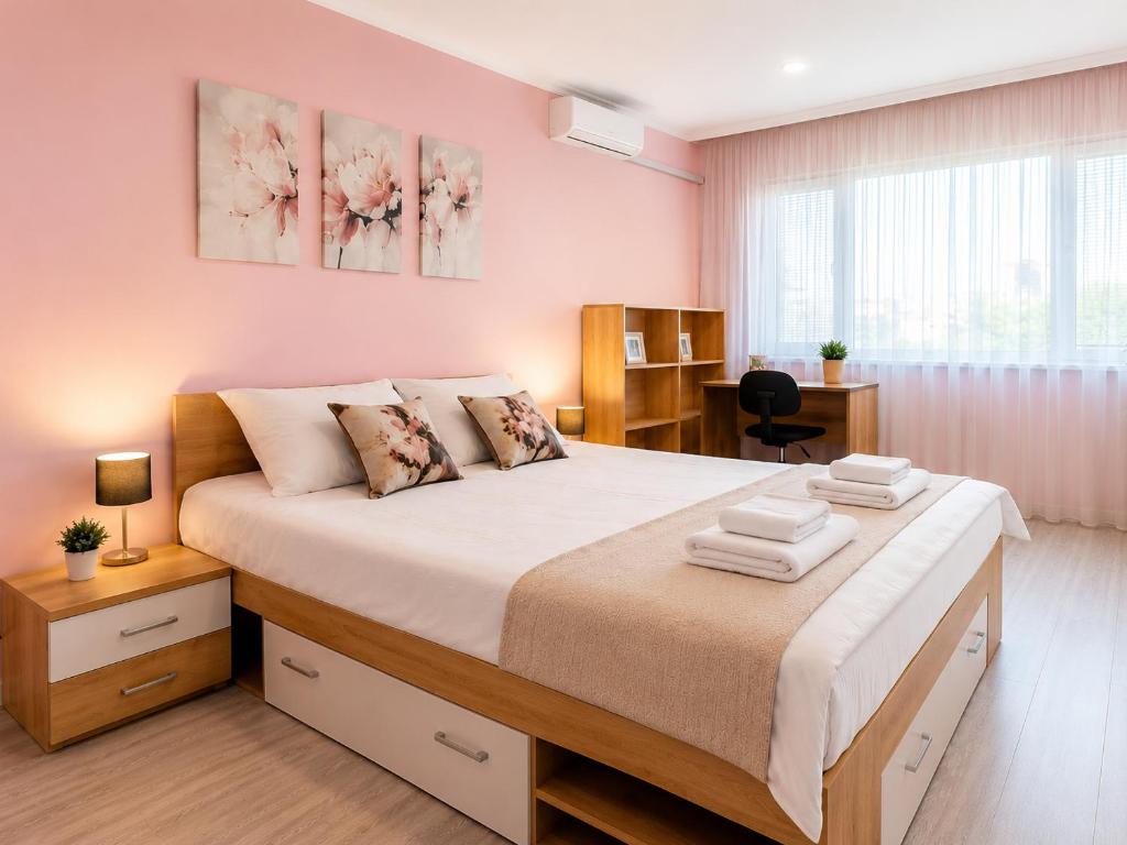 a bedroom with a large bed and a desk at P51 Central - Modern 2 Bedroom Apartment in Stara Zagora