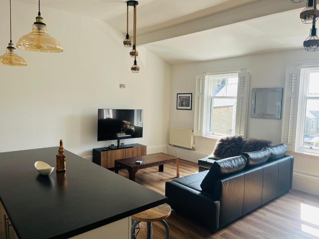 a living room with a couch and a table at Venue Apartment in Colne