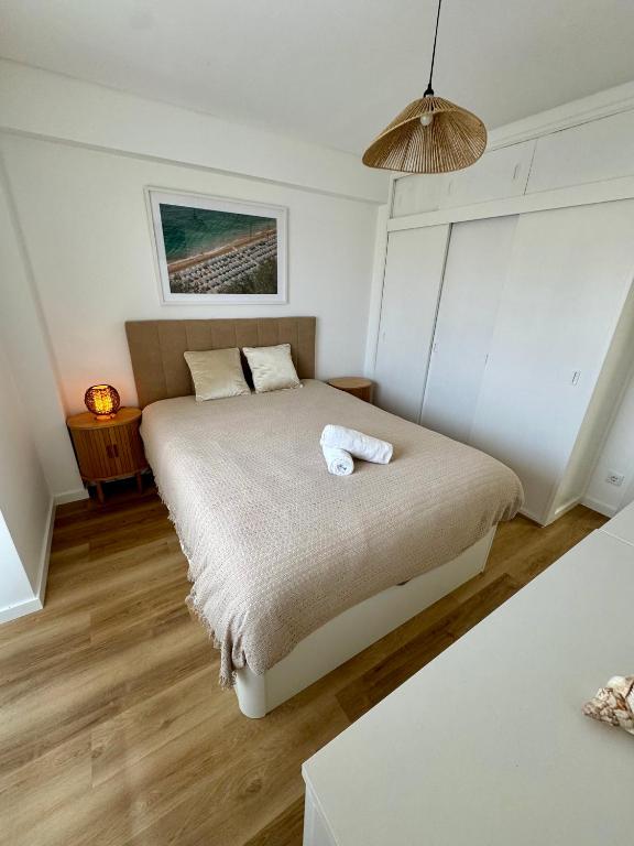 a bedroom with a bed with a towel on it at Casa Oceano 59 in Costa da Caparica
