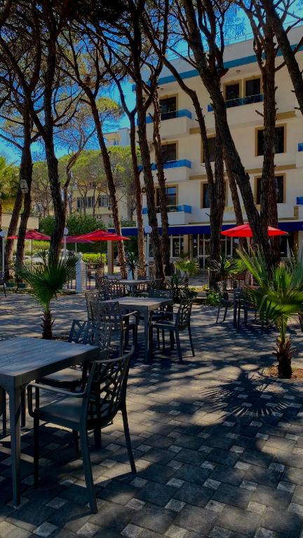 a group of tables and chairs in front of a building at Hotel Ylberi in Golem