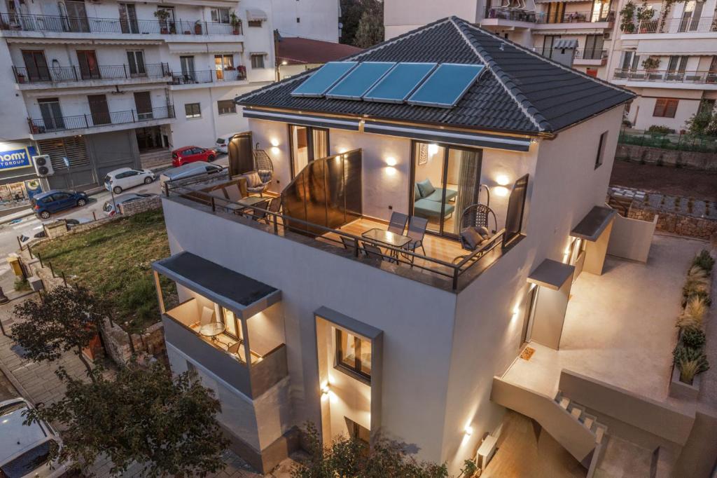 an aerial view of a house with a solar roof at Grava Aurum - City Suites in Igoumenitsa