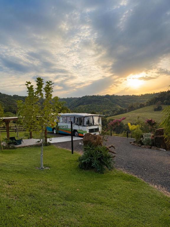 a bus parked on a road in a field at Refúgio Da Lua - Buss motorhome in Ametista do Sul