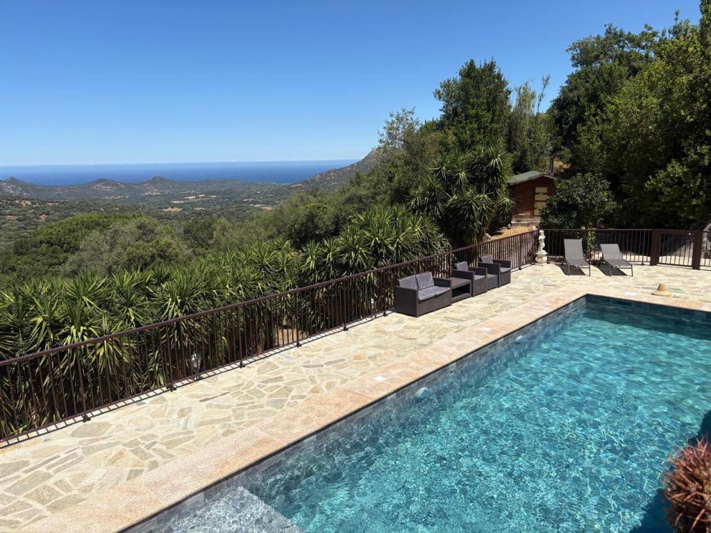 a swimming pool with a view of the mountains at costa di sognu in Costa