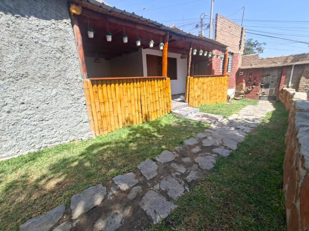 a house with a yellow fence in front of it at villa vilcar in Cali