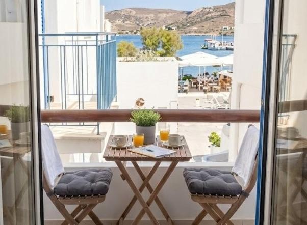 a table on a balcony with a view of the ocean at Harmony Serifos in Livadi