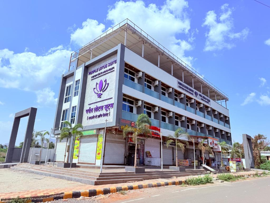 a building with a sign on the side of it at Hotel Purple Lotus Suites in Chauk
