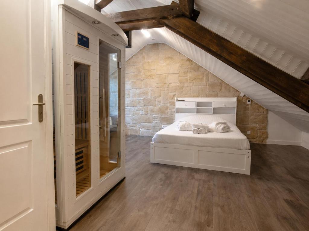 a bedroom with a bed in a attic at L'Opale - Sauna et Jacuzzi in Dijon