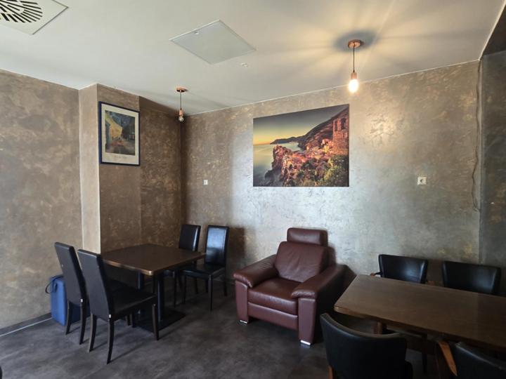a restaurant with a table and chairs and a table and a chair at Bruchsal Herz in Bruchsal