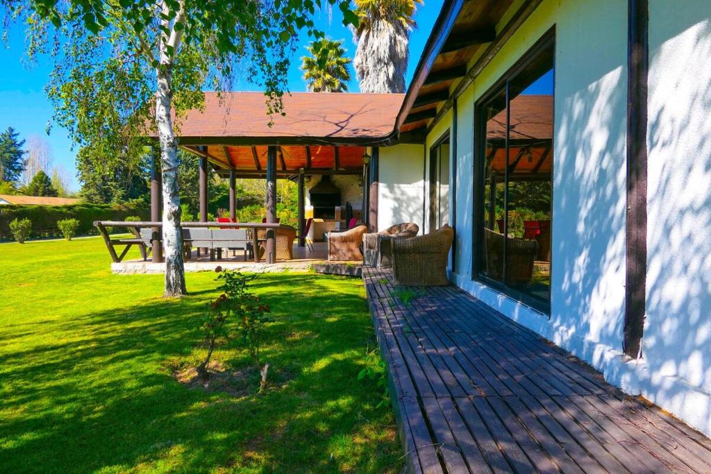 a house with a covered porch with a picnic table at Lake Rapel, beautiful lake view in Las Cabras