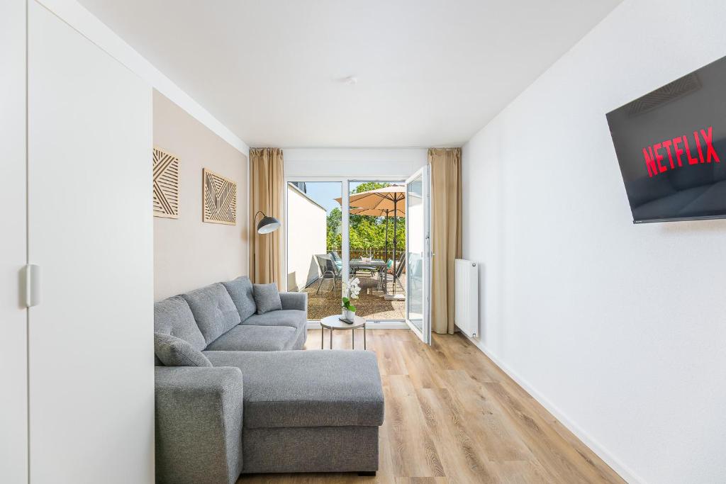 a living room with a couch and a tv at Ferienhaus Primavera in Mörsdorf