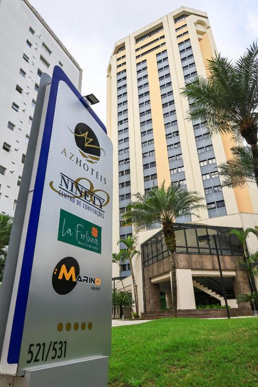a sign in front of a large building at Ninety Hotel in São Paulo