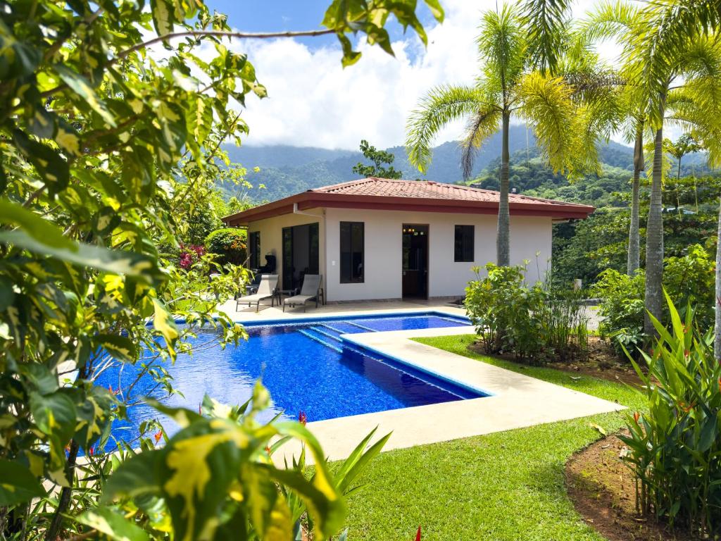 a villa with a swimming pool and a house at Villa Romancing The Stone in Ojochal
