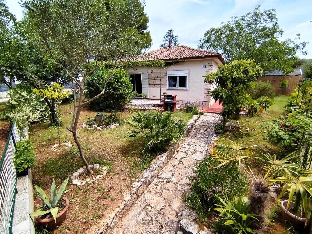 a house with a garden in front of it at Holiday home I.D.A. in Banjole