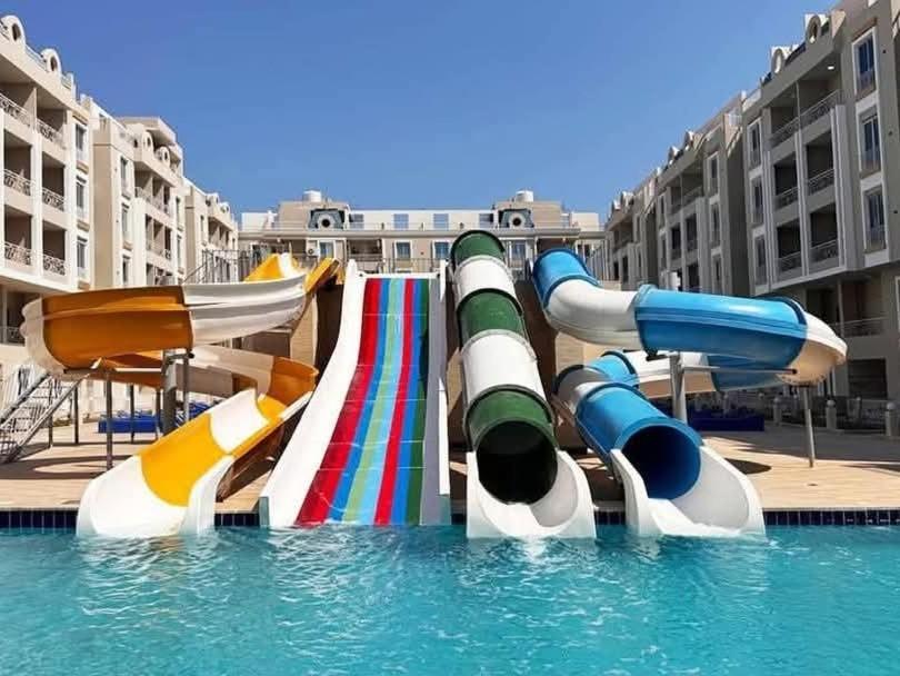 a water park with a water slide in a pool at Hurghada HuB in Hurghada