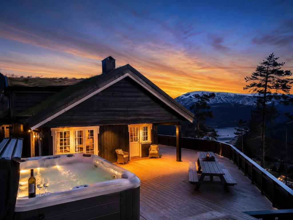 a hot tub on the deck of a house at Skyline Lodge in Stryn