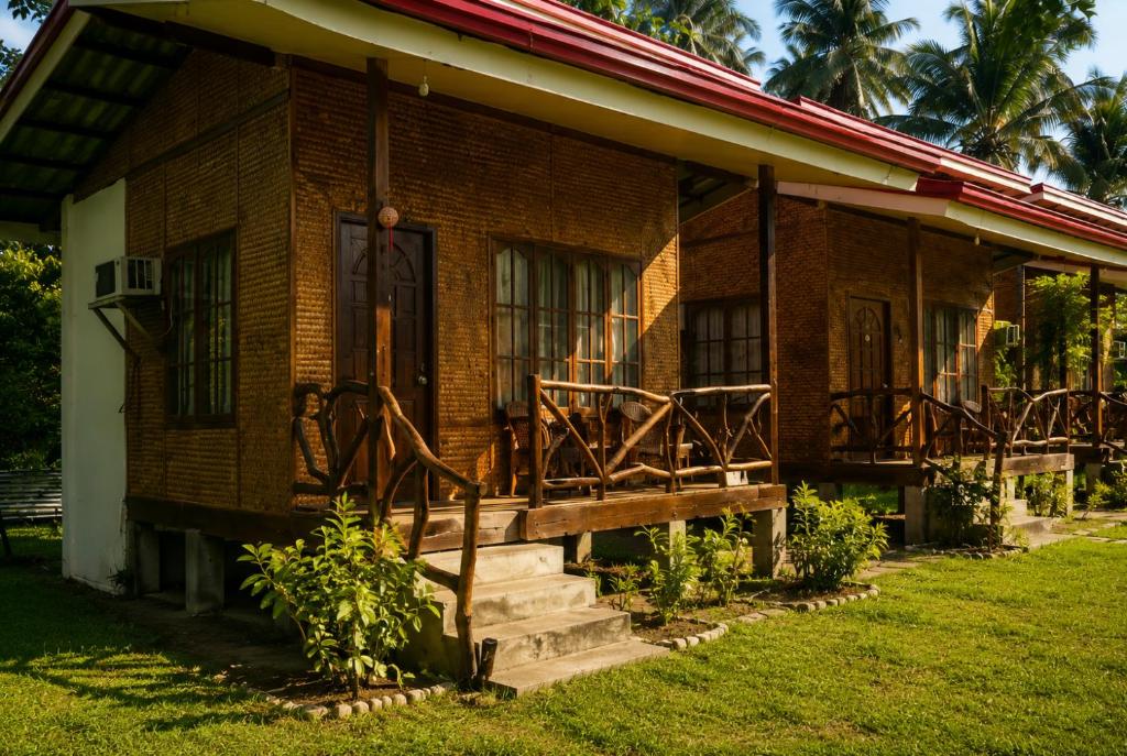 a brick house with a porch and stairs to it at Jurisu Resort in San Vicente
