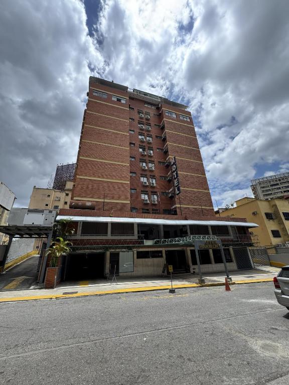 a large brick building on the corner of a street at Hotel Harmony in Caracas