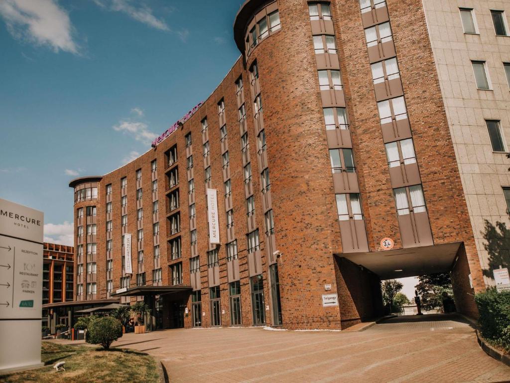 a large brick building with a tunnel in front of it at Mercure Hotel Hamburg City in Hamburg