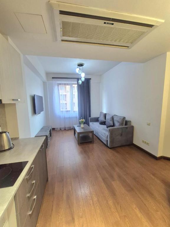 a living room with a couch and a table at Appartament Buzanda 17 in Yerevan