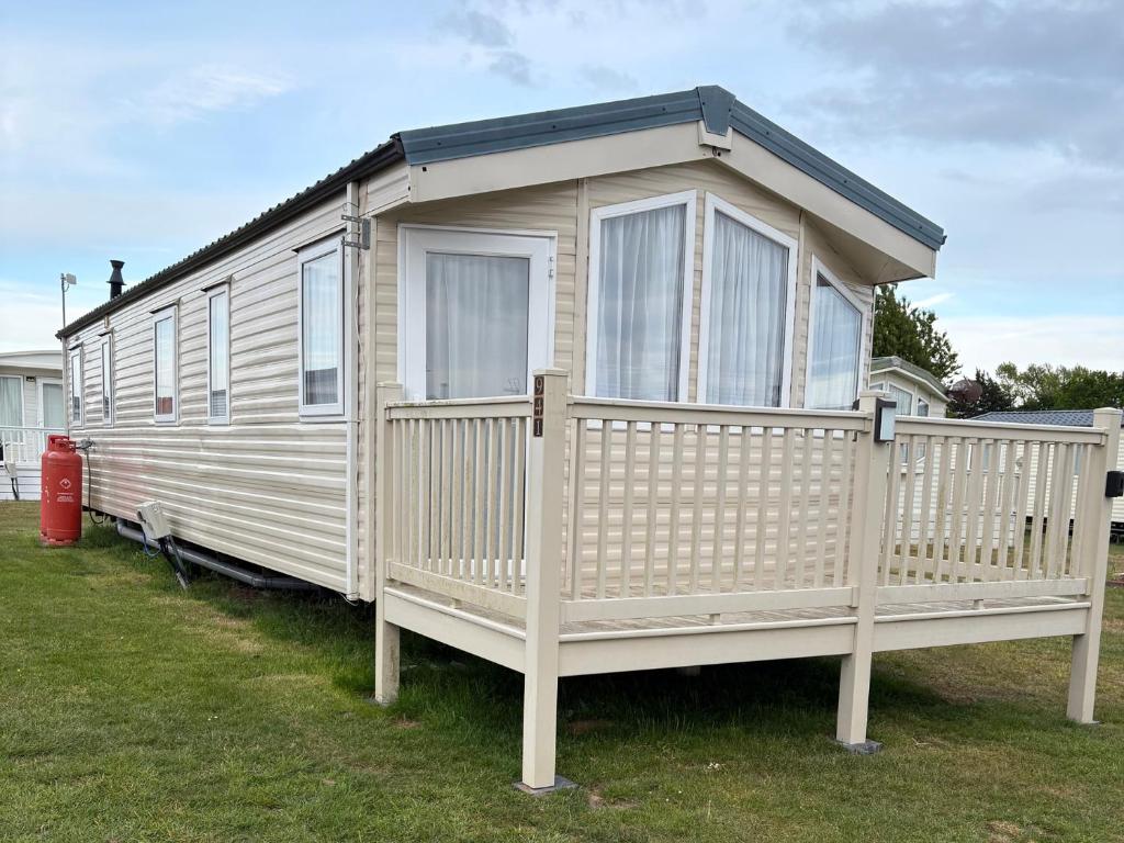 a white tiny house on display in a yard at Caravan 607 in Clacton-on-Sea
