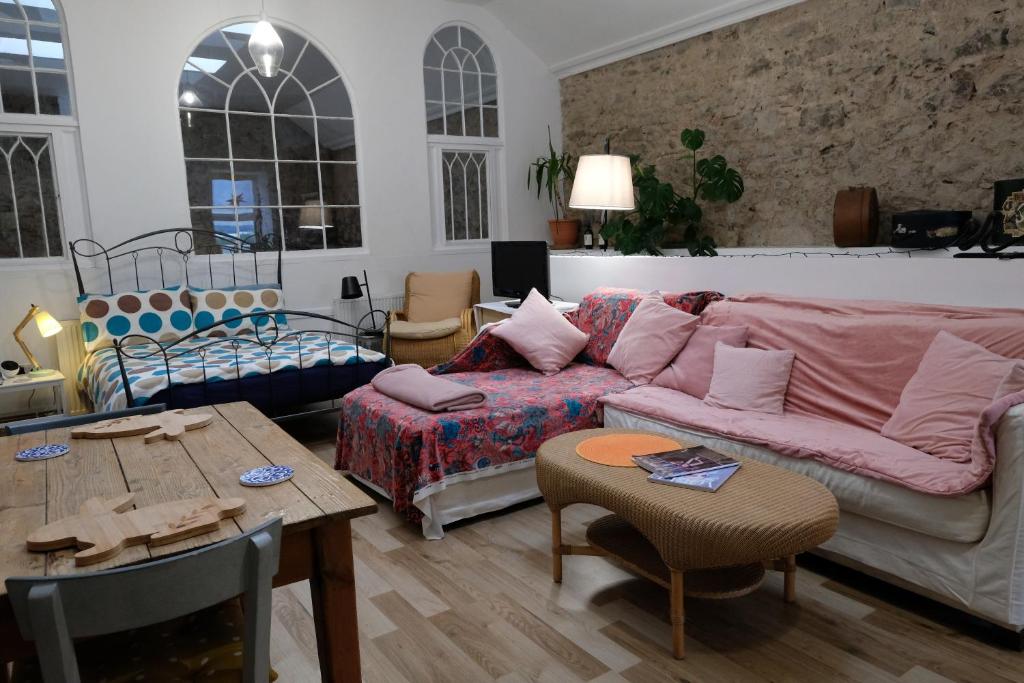a living room with a couch and a table at ‘Museum Loft’ Scotland’s Wee Hat Museum in Newburgh