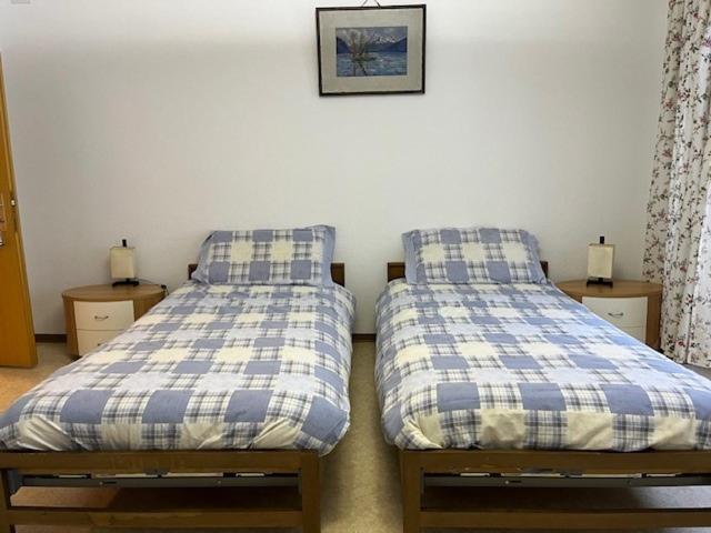 two beds sitting next to each other in a bedroom at pensione VAIS in Piotta