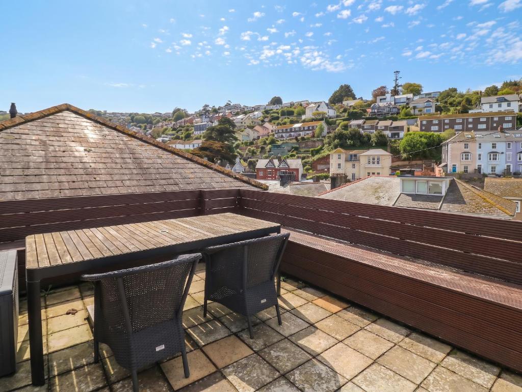 a balcony with two chairs and a table on a roof at Kipper Lodge in Dartmouth