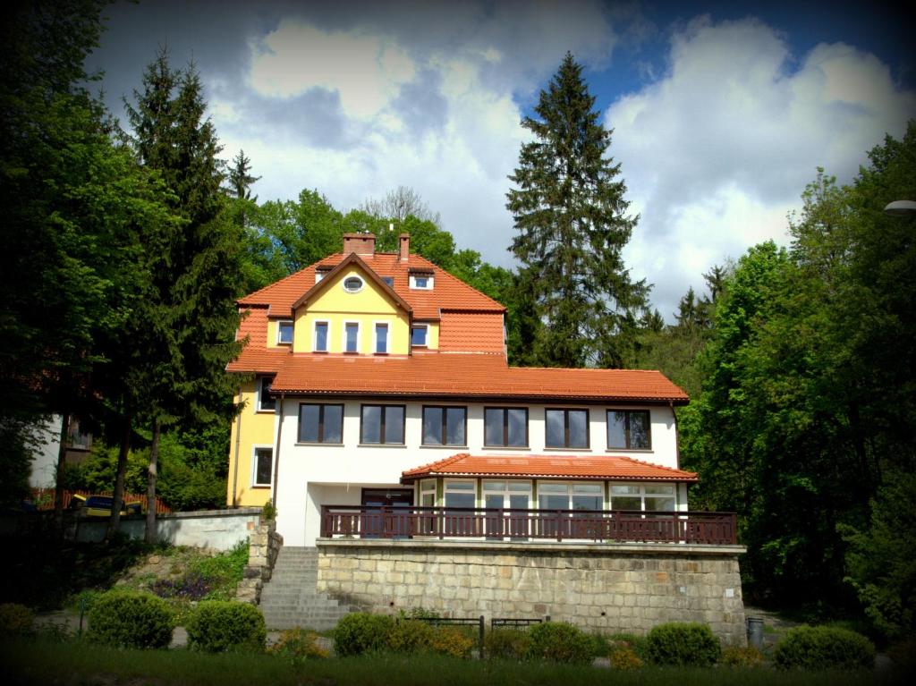 a house with an orange roof on top of it at Villa Góralka in Polanica-Zdrój