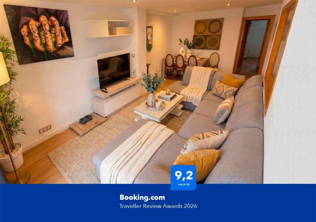 a living room with a couch and a tv at Apartalux Playa Diva in Grao de Castellón