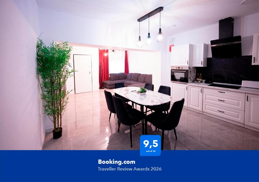 a kitchen and a dining room with a table and chairs at Apartalux Premium Suites in Grao de Castellón