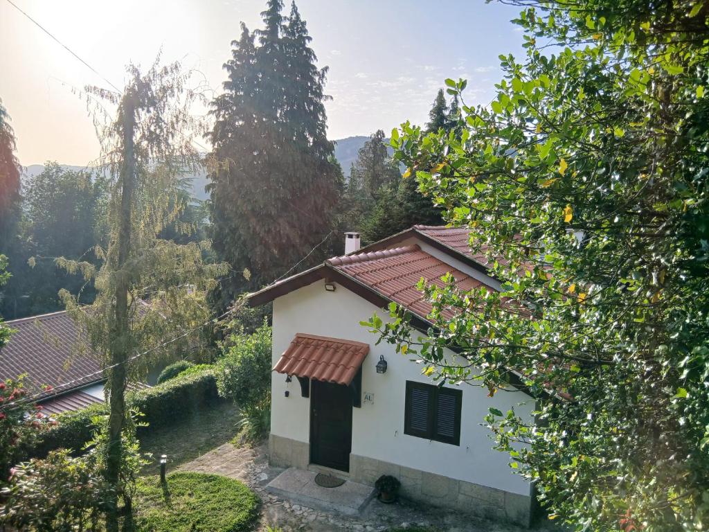 a small white house with a red roof at Gerês by Papitravel in Vieira do Minho