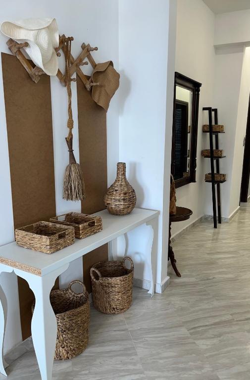 a room with a table with baskets on it at la PADINI CASA sul mare in Neoi Epivates