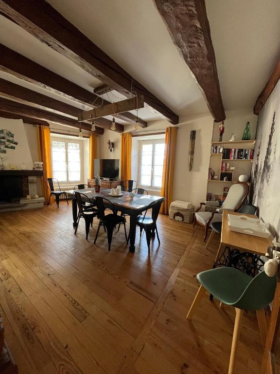 a large living room with a table and chairs at Murat - Le Duplex By Murat in Murat