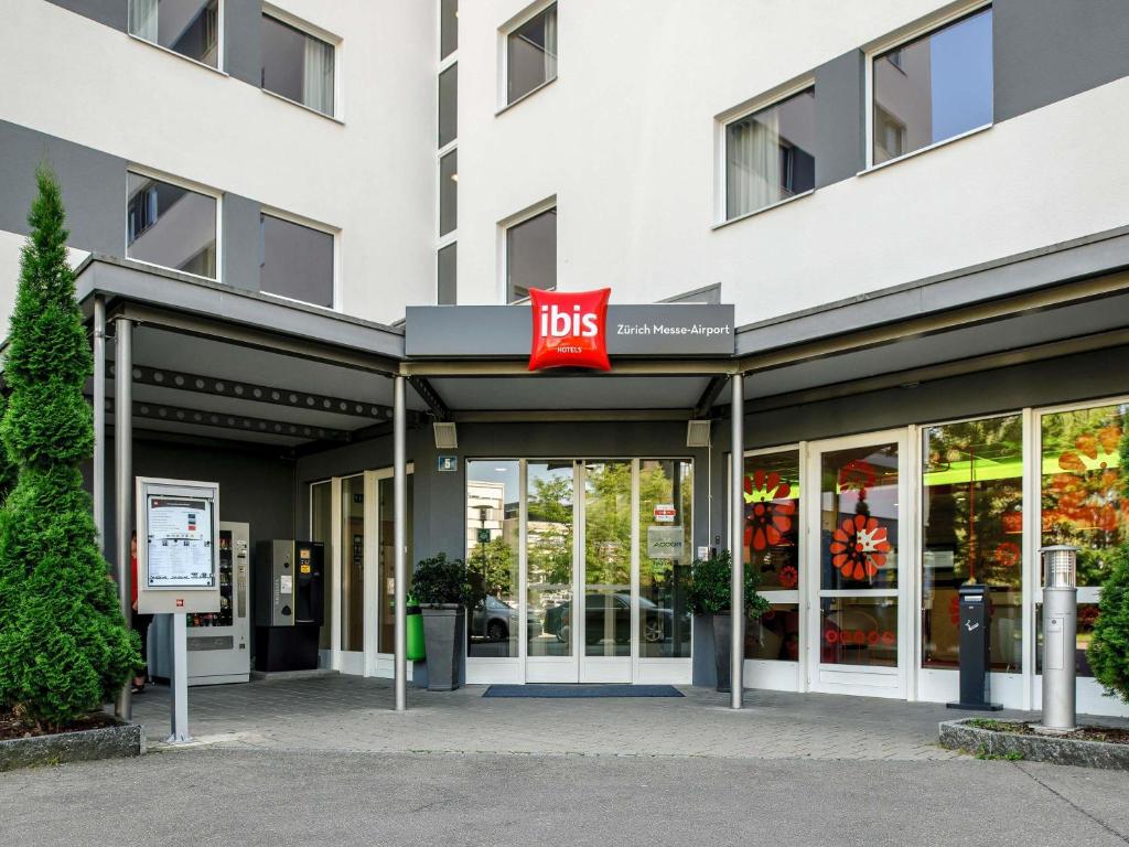 a store front of a building with a ups sign at ibis Zürich Messe Airport in Zurich