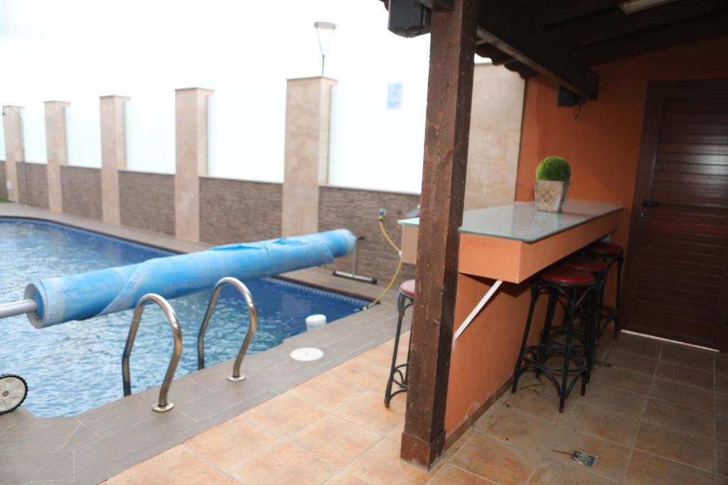 a swimming pool with a blue inflatable at Villa de Lujo con Piscina A 5 min de San Juan de los Terreros in Pulpí