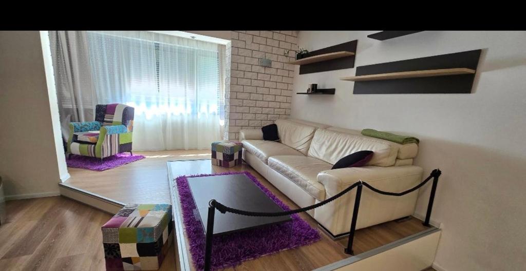 a living room with a couch and a table at Apartman Jo Ma MA in Solin