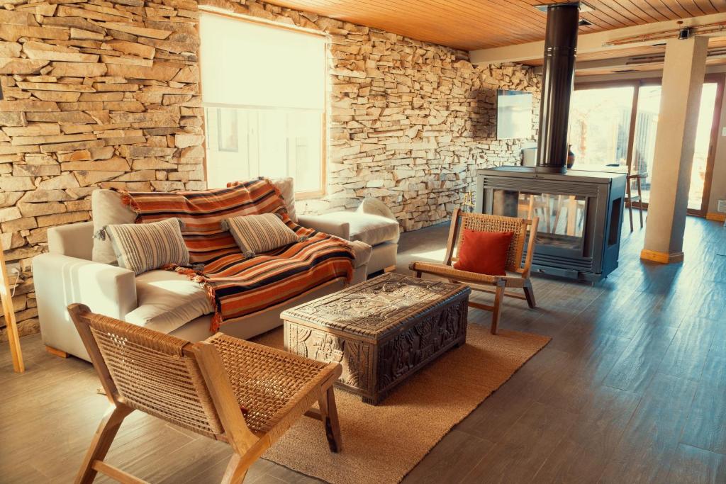 a living room with a couch and a fireplace at Black Hills Caviahue in Caviahue