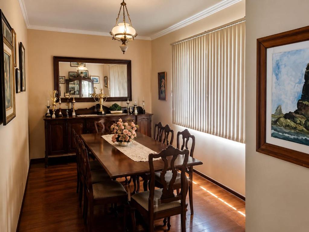a dining room with a table and chairs at Quarto Comary in Teresópolis
