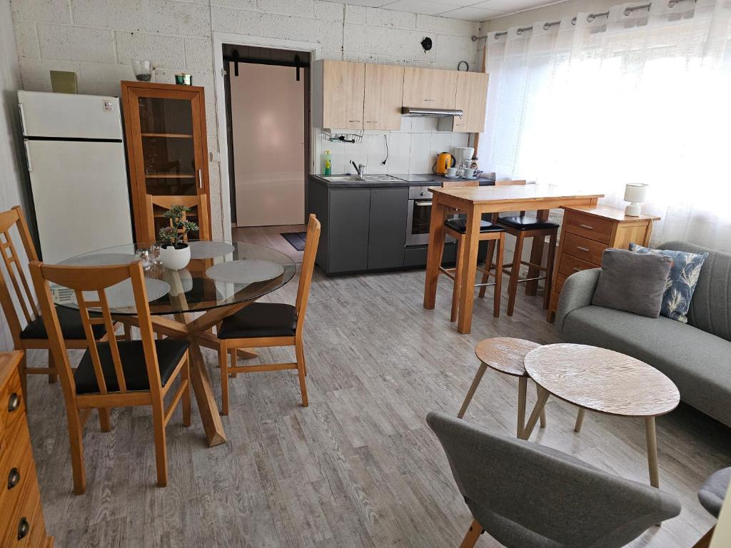 a kitchen and a living room with a table and chairs at Leilighet 6 in Dalen