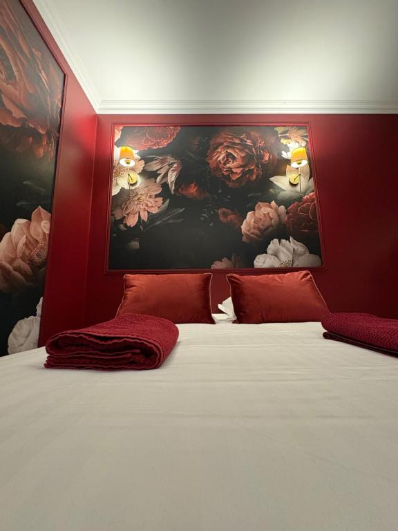 a bedroom with a large bed with a painting on the wall at Domaine Des Hêtres in Longraye