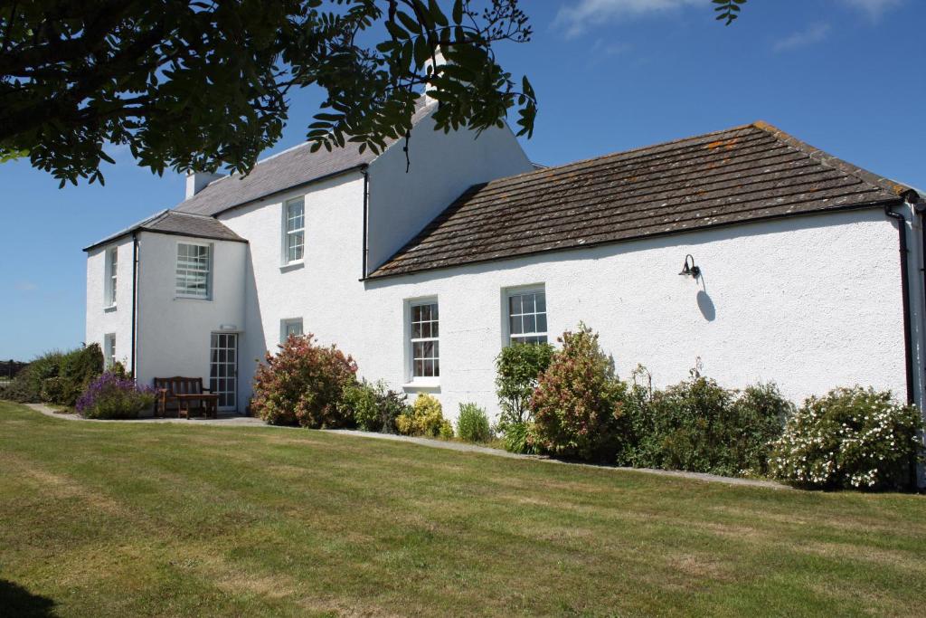 a white house with a yard in front of it at Skerrols House in Bridgend