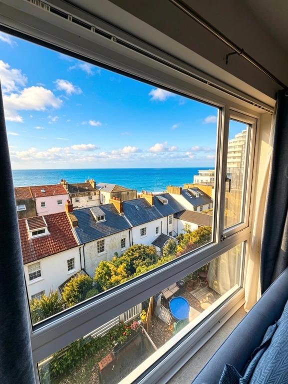 a view of the ocean from a window at Captain Normans Sea view in Hollington