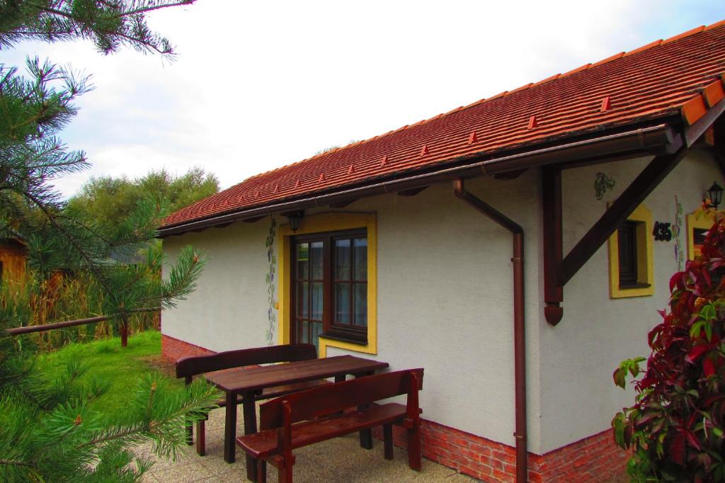 a building with a picnic table and two benches at Chata u vinára Milana, Tatralandia in Liptovský Mikuláš