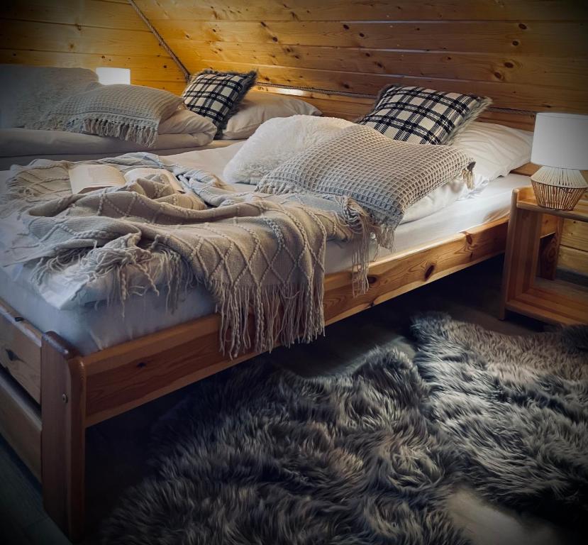 a bedroom with two beds and a rug at Domki Zielony Raj Rabka- Zdrój Jacuzii na wyłączność Sauna in Rabka-Zdrój