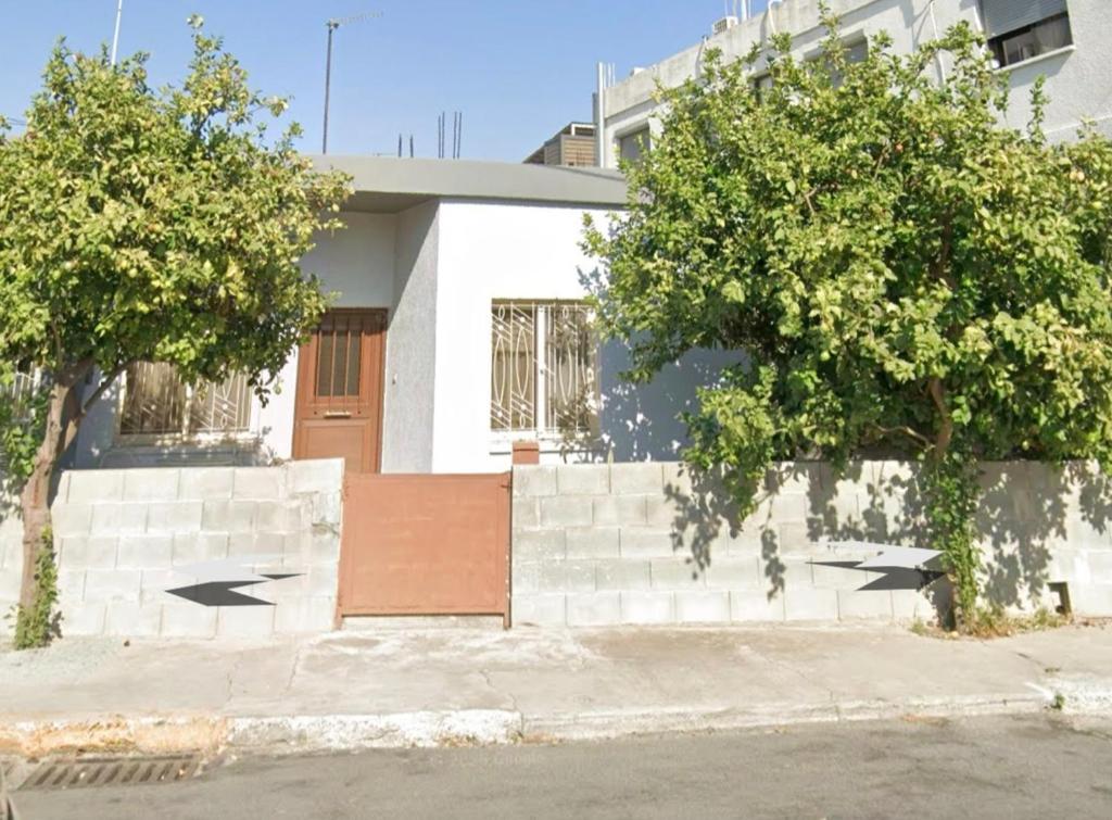 a white building with trees in front of it at Xrysanthis Kaouris in Limassol