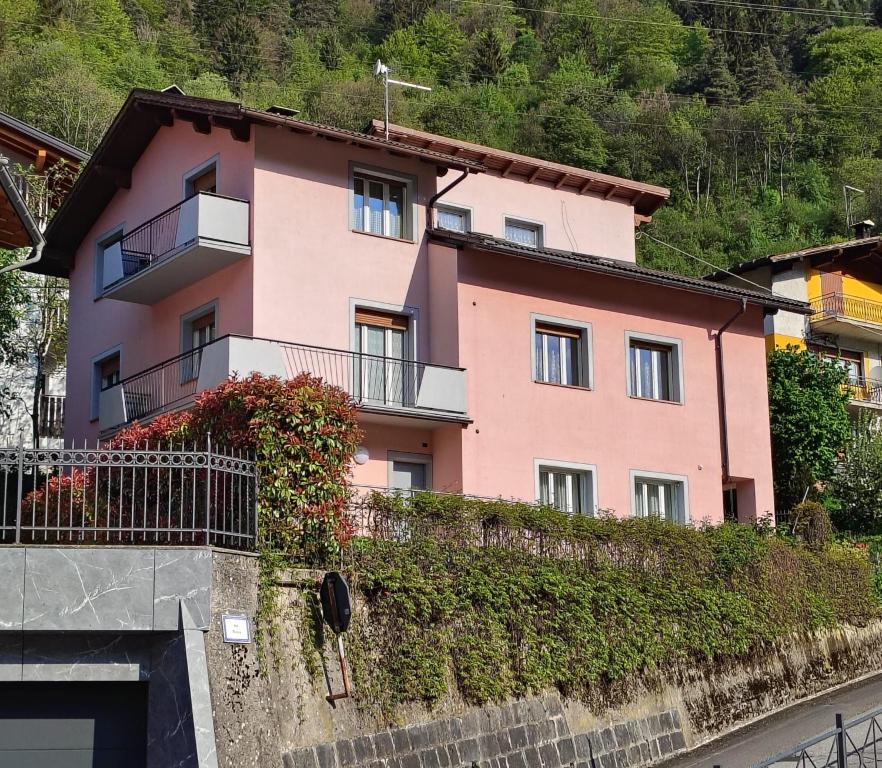 a pink house on the side of a mountain at la casa rosa in Breguzzo