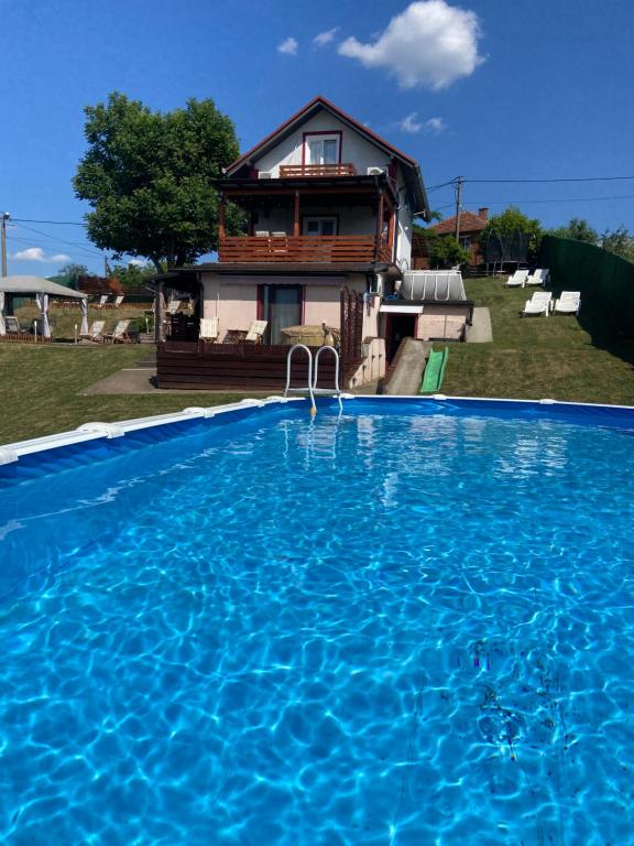 a house with a swimming pool in front of a house at Avala Sunset Apartments in Belgrade