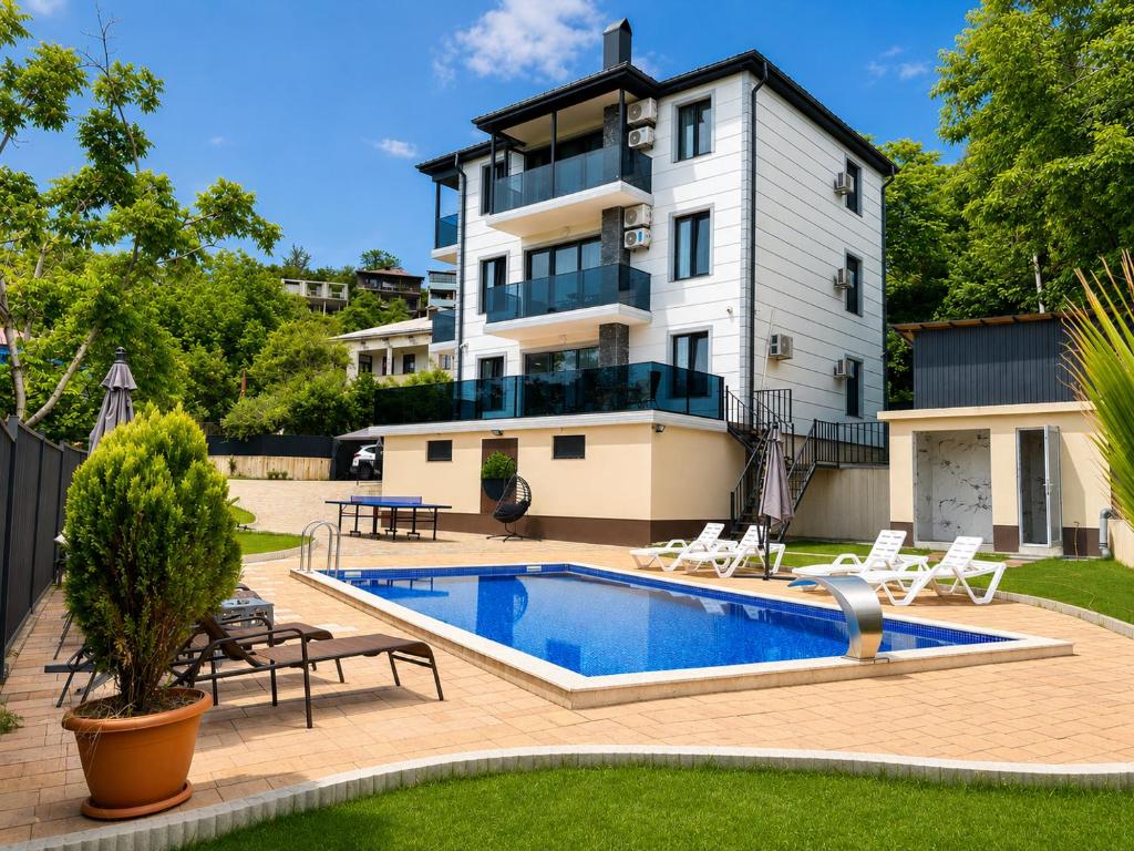 a house with a swimming pool in front of a house at phranta in Gonio