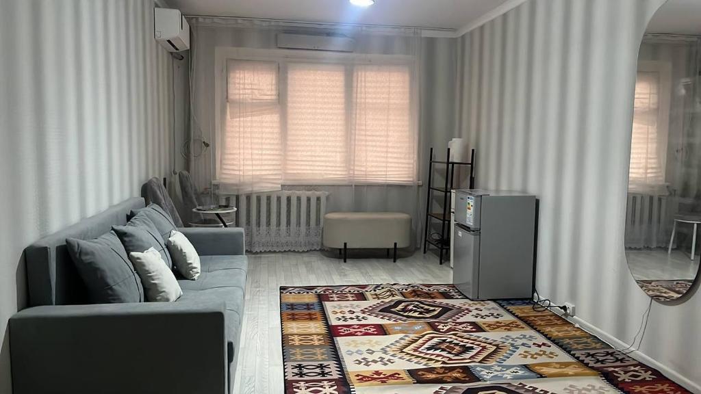 a living room with a couch and a rug at Квартира у озера in Priozersk